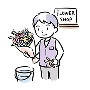 フラワーショップの店先で色とりどりの花束と園芸バサミを持って微笑む男性花屋店員